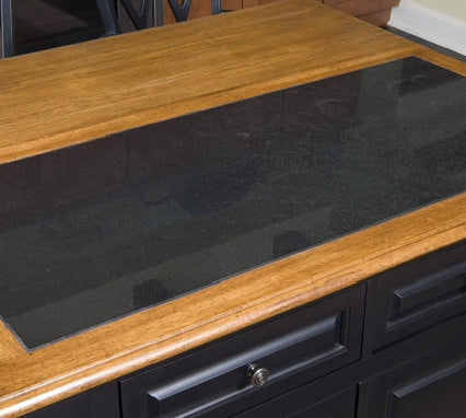Black countertop with wooden edge on a kitchen island