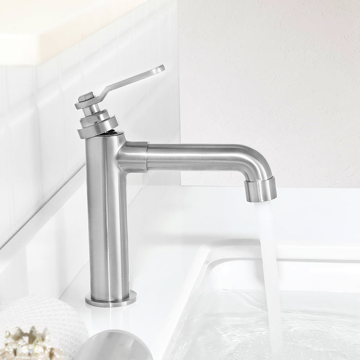 Chrome kitchen faucet on a white tiled wall background