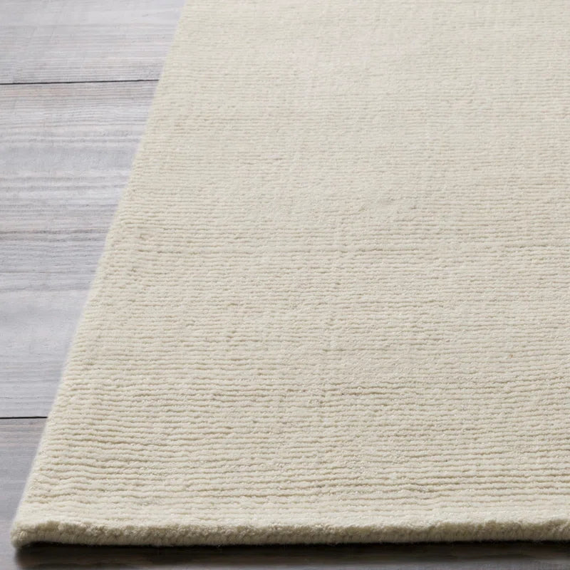Beige rug on a wooden floor