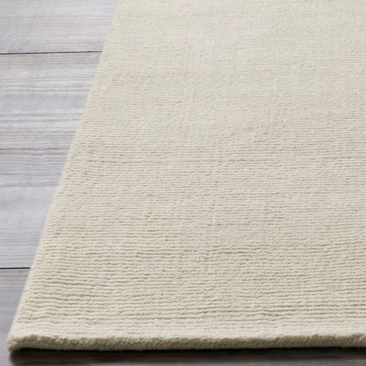 Beige rug on a wooden floor