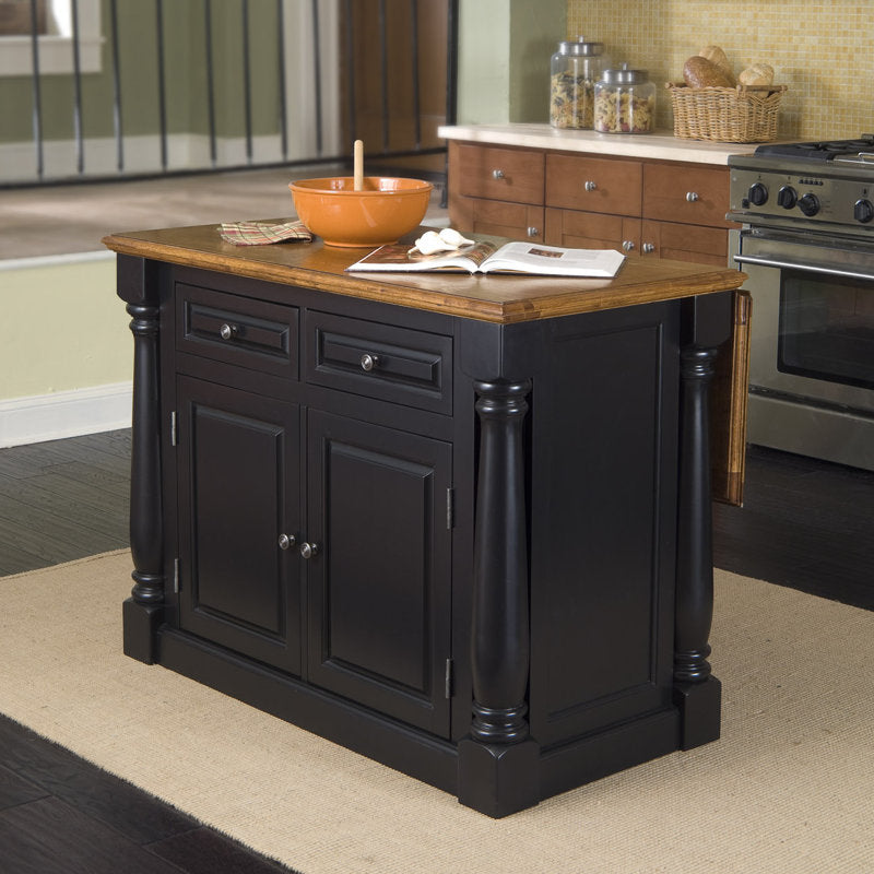Kitchen island with wooden top and black base in a kitchen setting