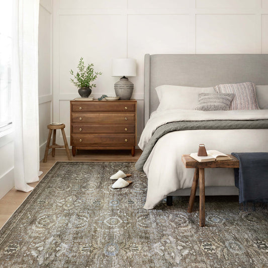 Bedroom with a gray rug, wooden nightstands, and a bed with white bedding.