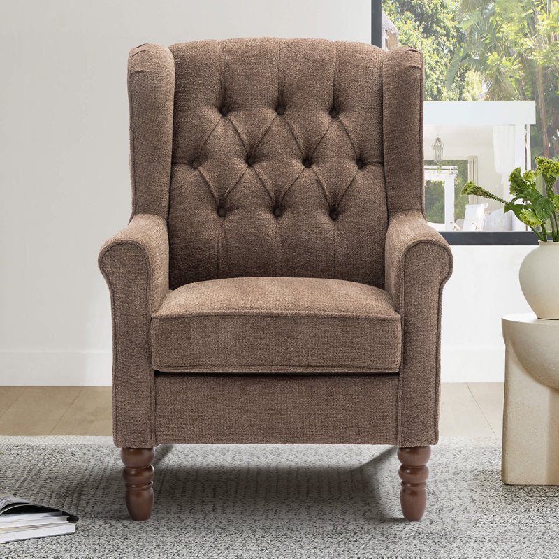 Brown upholstered armchair in a room with a window and plant