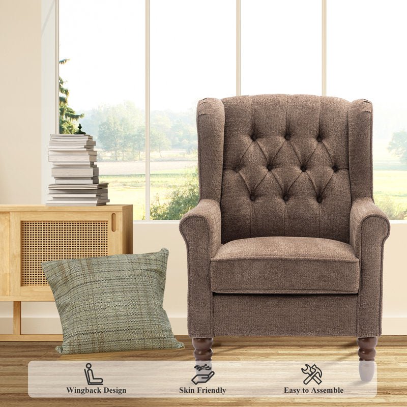 Brown tufted armchair with a pillow in a room with large windows.