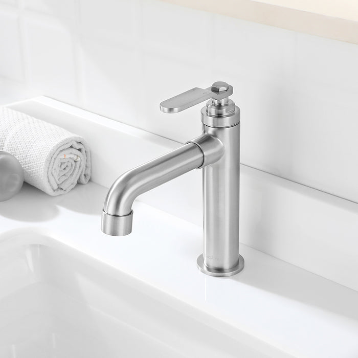 Stainless steel faucet on a white sink with a neutral background