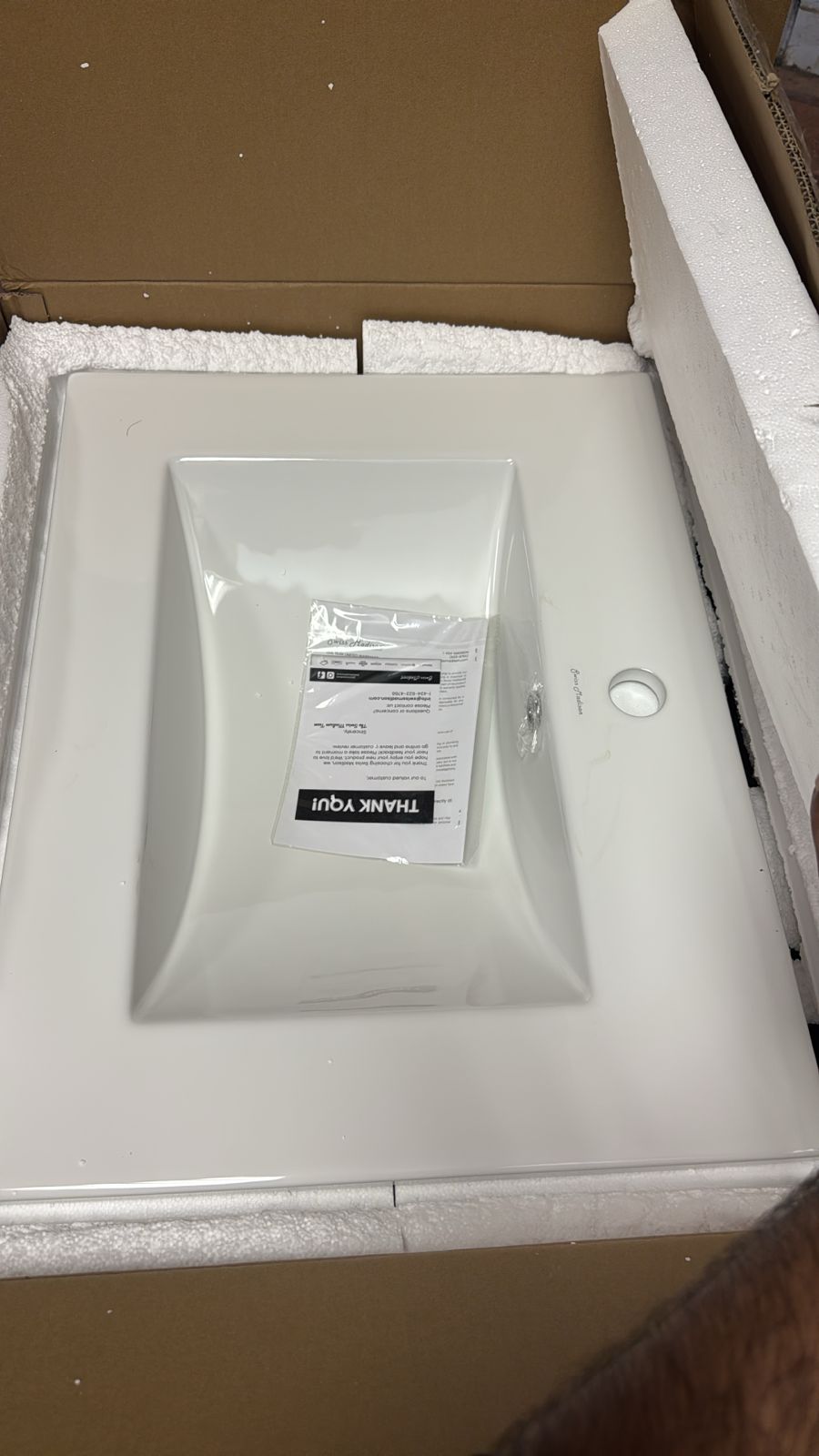 White ceramic vanity top with overflow and faucet hole
