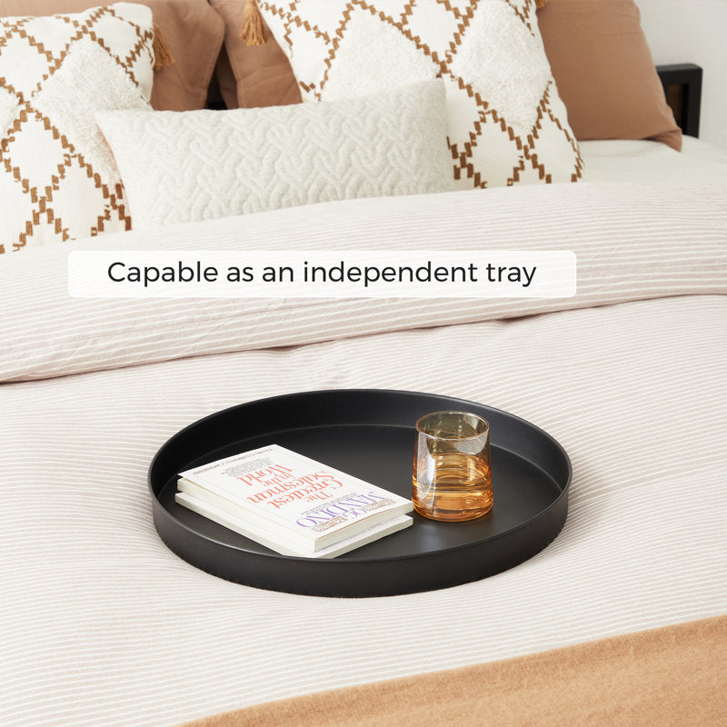 Black tray on a bed with a glass and book, text 'Capable as an independent tray' above.